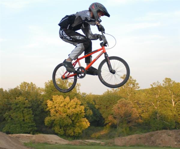 a kid riding a BMX bike